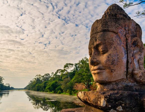 Siem-Reap-Details-of-Stone-faces-sculpture-and-rock-carvings-at-gate-of-Bayon-wat-in-Angkor-Thom-temple